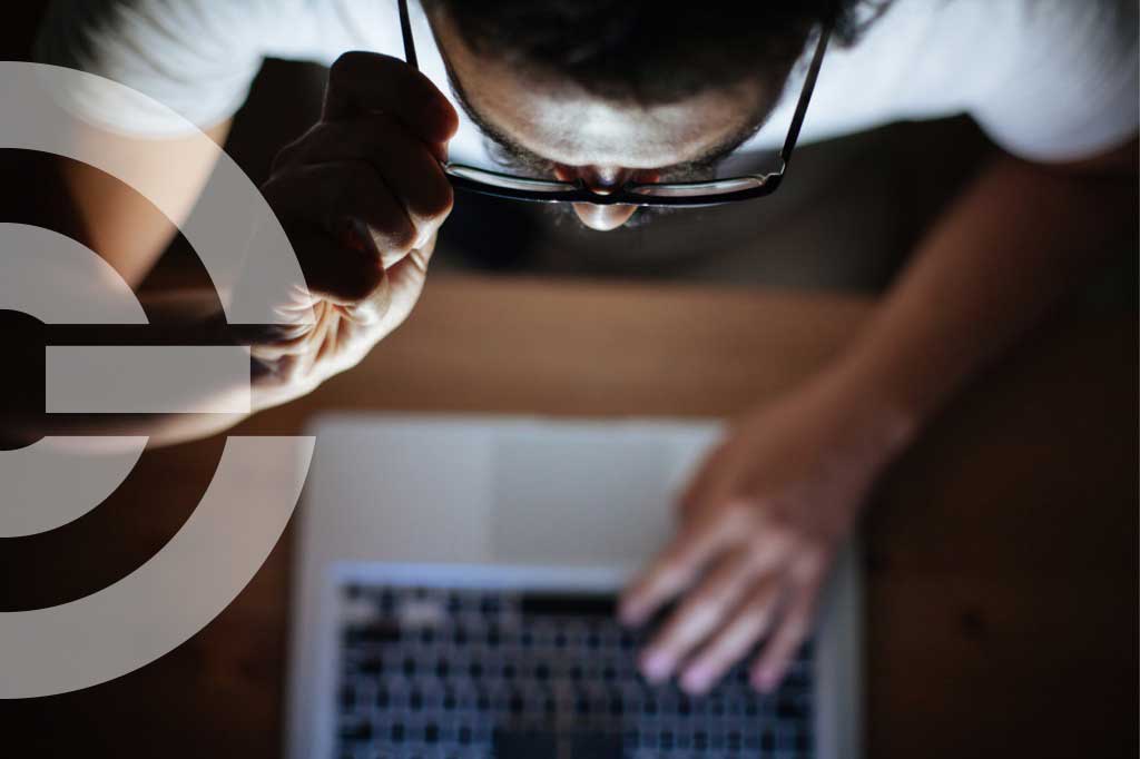 man looking suspiciously at computer