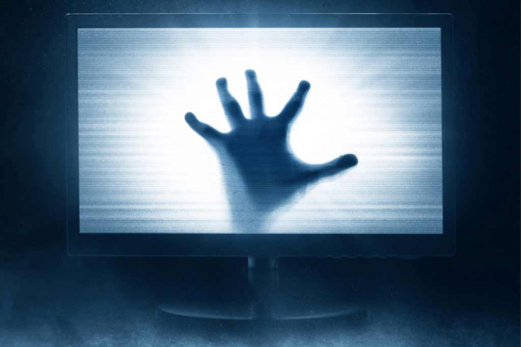 Nightmare hand reaching through monitor