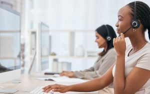 Call center, customer service and business woman consulting on computer in modern office