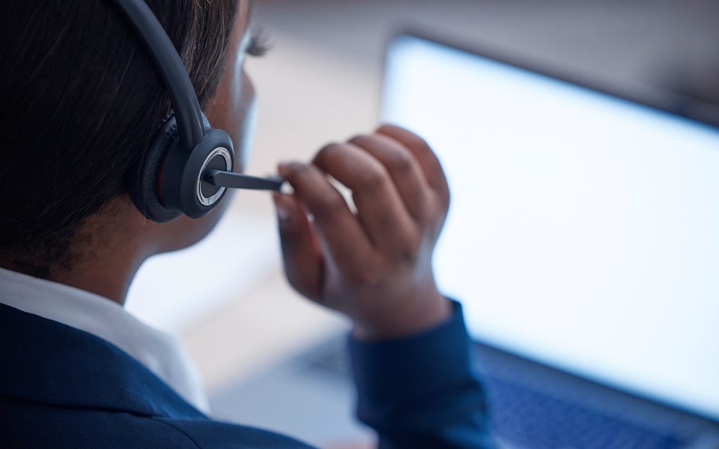 Side view of a woman with a headset on at call center